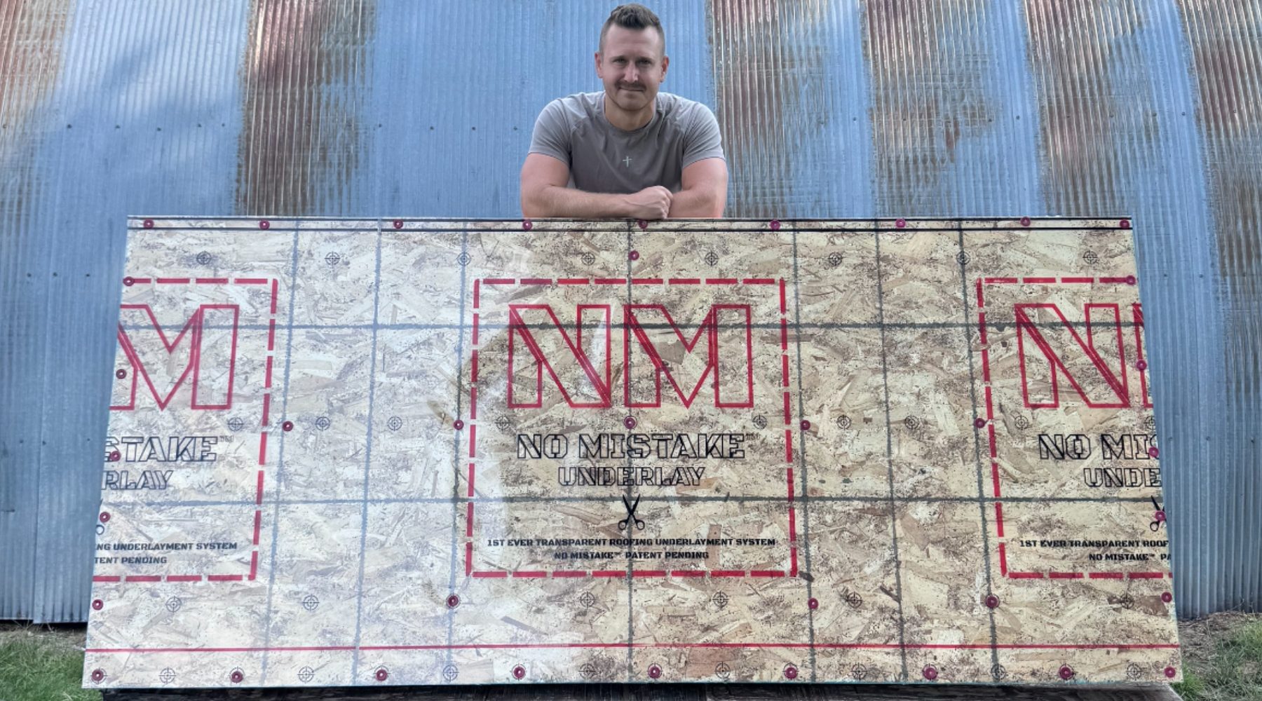 Evan standing behind a full roll of NO MISTAKE Underlay laid over roof decking.